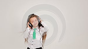 A little girl with her headphones waving her hand