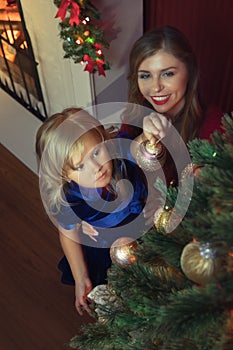 little girl with her mama in christmas environment