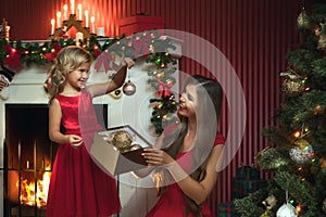 Little girl with her mama in christmas environment