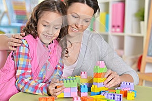 little girl and her mother playing