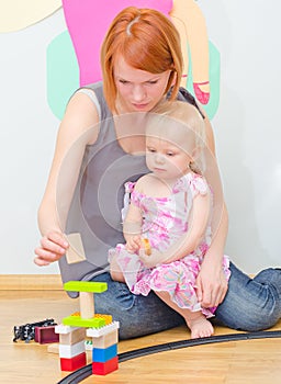 Little girl and her mother playing.