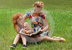 Little girl and her mother read book