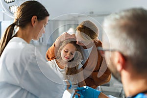 Little girl with her mother in surgery examination.