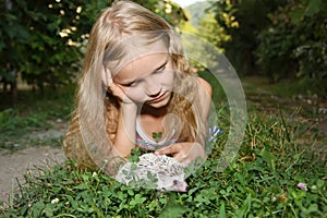 Little girl with her pet African pygmy hedgehog