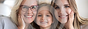 Little girl her young mother and mature grandma family portrait photo