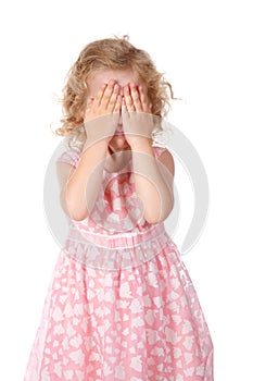 Little girl hide face under hands