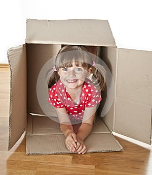 Little girl hiden inside a paper box