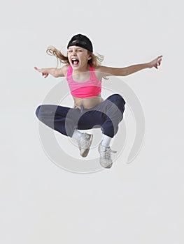 little girl hip hop dancer jumping in studio