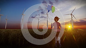 Little Girl holding Balloons on wheat field with Wind Turbines Farm at sunset, 4K