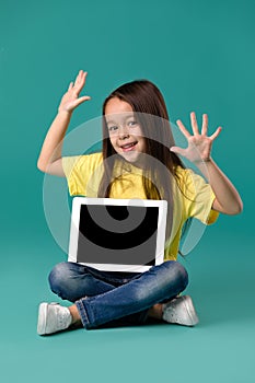 Little girl holding a blank tablet computer