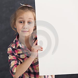 Little girl holding blank white banner