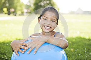 Little girl holding blue ball