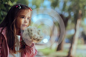 Little Girl Holding a Bouquet of Dandelions in Spring Season