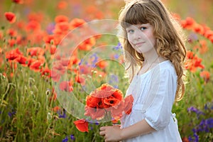Little girl holding a bouquet poppies
