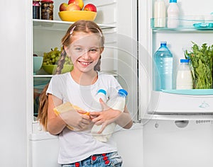 Little girl holding cheese and milk