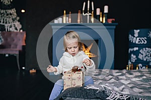 Little girl holding a Christmas gift box.