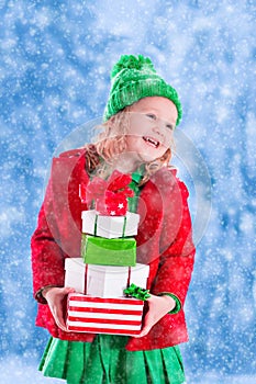 Little girl holding Christmas presents