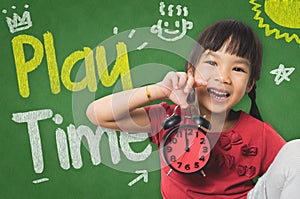 Little girl is holding a clock for playtime