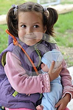 Little girl holding a doll