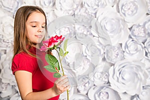 Little girl holding a flower in her hand