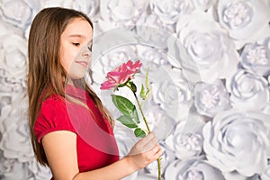 Little girl holding a flower in her hand