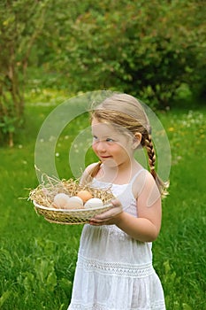 Little girl holding fresh eggs