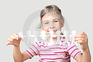 Little girl holding garland of paper little people