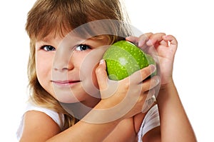 Little girl holding green apple