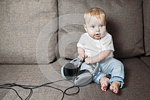 Little girl holding in hands big headphones