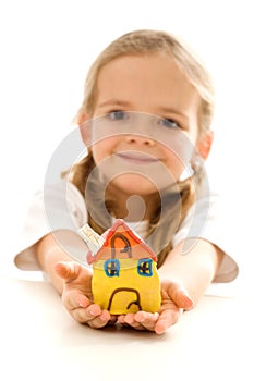 Little girl holding her clay house