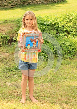 Little girl holding her picture