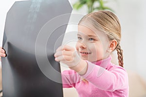 Little girl holding her radiogram photo