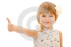 Little girl holding her thumb up