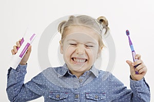 Little girl holding her toothbrush and toothpaste