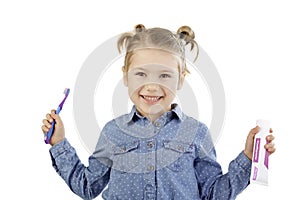 Little girl holding her toothbrush and toothpaste