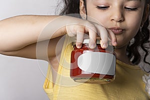 Little girl holding a homemade tomato paste in hand mock-up series