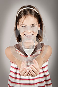 Little girl holding an hourglass