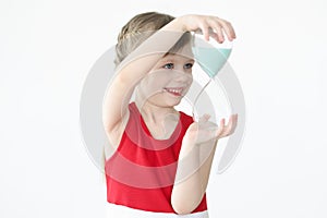 Little girl holding hourglass in her hands