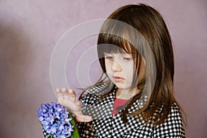 Little Girl holding hyacinth in flower pot