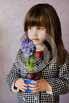 Little Girl holding hyacinth in flower pot