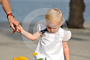 A little girl holding mother hand