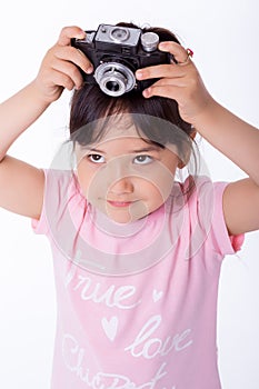 Little girl holding an old camera