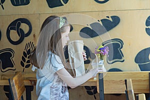 Little girl holding a paper bag with food in her hands