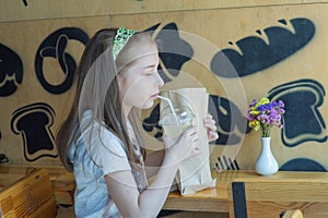 Little girl holding a paper bag with food in her hands