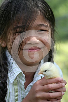 Little girl holding pet chick