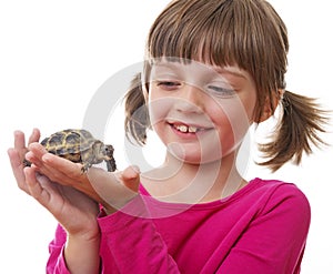 little girl holding a pet turtle