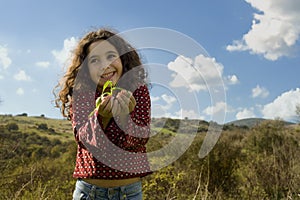 Little girl holding plant