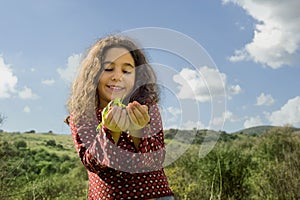 Little girl holding plant