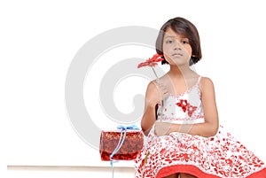 Little girl holding red flower