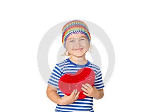 Little girl holding a red heart toy.